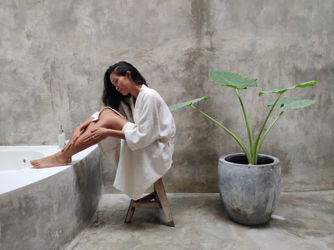 Woman in bathrobe in luxury bathroom