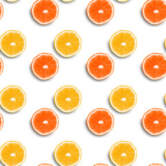 seamless texture,  orange and greyfruth sliced ​​into rings on a colored background