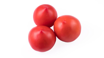 three tomatoes on a white background