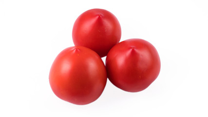 three tomatoes on a white background