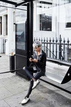 Woman waiting at bus station.
