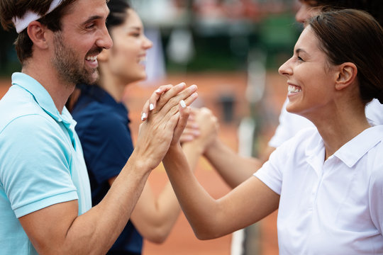 Group of tennis players giving a handshake after a match