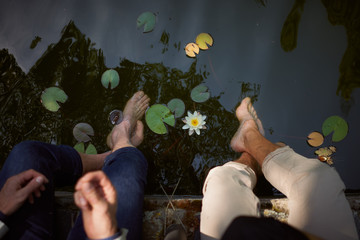 Legs of two men in a lake