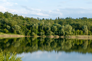 Fototapeta premium beautiful summer lake against the background of high mountains and blue sky