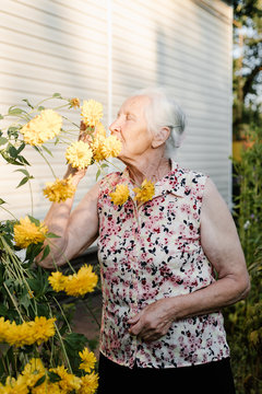 Senior Woman Smelling Flowers