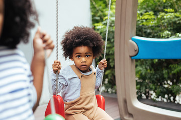 Portrait of a Boy on a Swing