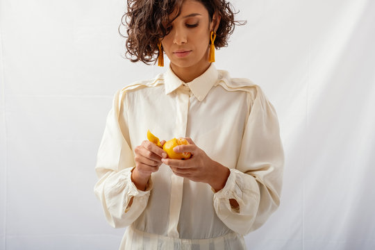 Model Wearing Natural Fabrics And Holding Fruit