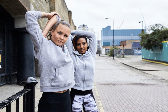 Runners stretching arms.