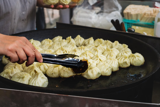 japanese food vendor frying dumplings