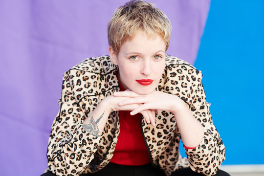 Attractive blonde woman with red lips and piercing.