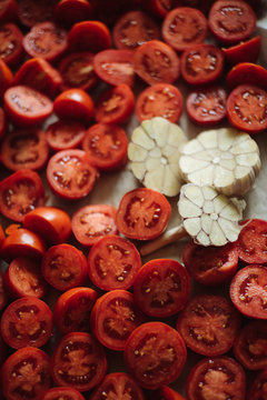 Tasty tomatoes with garlic on baking pan