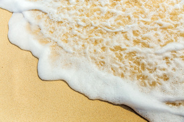 Fototapeta na wymiar Sea surf, foam and sand