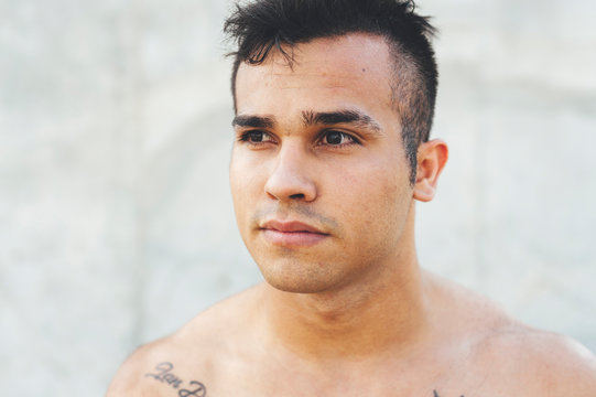 Head shot of young muscular break dancer looking at horizon in urban scenery