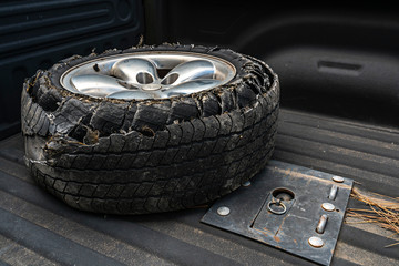 Blown tire in the bed of a pick up truck.