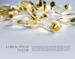  Yellow gelatin capsules with a  drug Omega-3  on a grey background. Alternative treatment, beneficial body support fatty acids for good health