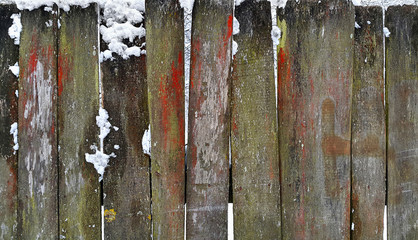 Old wooden fence in winter