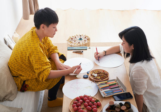 Asian women are doing painting art at home