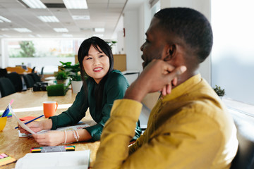 Multiethnic couple working in stylish office