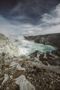 sulfur mine beside acid lake on mount ijen