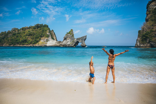 mother and son having fun at a tropical paradise beach