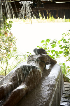 Woman receiving a vichy shower massage at luxury spa