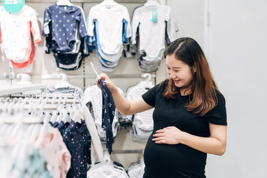 Pregnant Woman Shopping For Baby Clothes