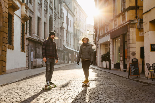 Adult couple longboarding together