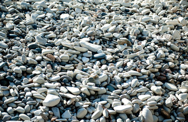 Smooth stones, pebbles on the beach by the sea. Stony coast, Cyprus, the Mediterranean Sea.