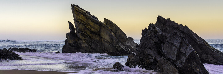 Amazing cliff rocks on the west coast of Portugal on Adraga beach at sunrise