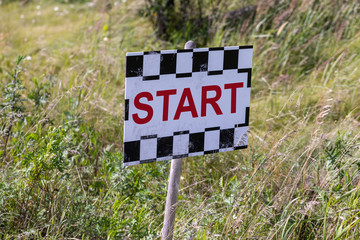 Start sign in the grass lolly close up