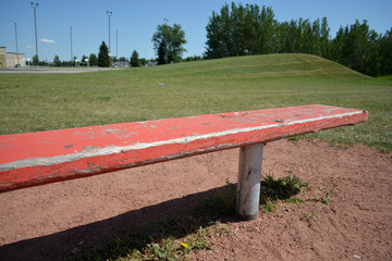 Bench at basefield field at a local community park.