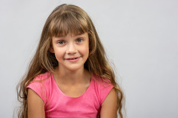 Portrait of a surprised beautiful eight-year cheerful European girl