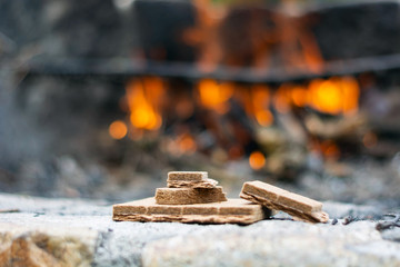 starting kindling for a fire in the background of a flame.