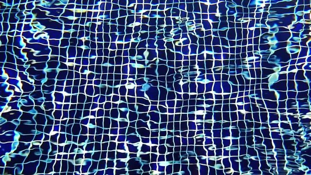 Close-up Shot Of Pool Water features a close-up shot of the clear blue waters of a swimming pool. It appears like the video was taken on a sunny day and the pool looks clean and soothing.