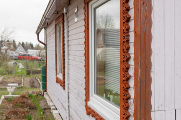 part of the country house on the site is decorated with wooden patterns along the contour of the...
