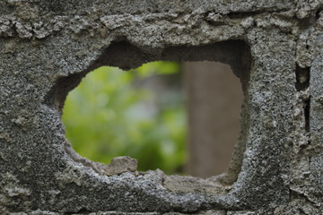 The picture of the hole in the wall that was broken and saw outside