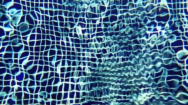 Close-up Shot Of Pool Water features a close-up shot of the clear blue waters of a swimming pool. It appears like the video was taken on a sunny day and the pool looks clean and soothing.