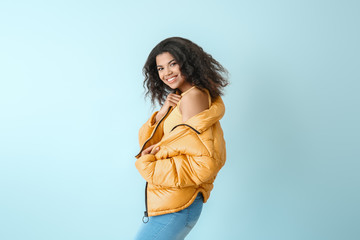 Portrait of stylish African-American woman on color background