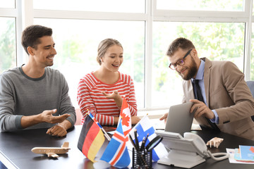 Fototapeta premium Male travel agent working with young couple in office