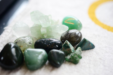 Lush green crystal collection, Green Quartz, Malachite, Peridot, Fluorite, rainforest jasper, and Quantum Quattro. Prosperity and abundance healing crystal collection. White background, bright colors