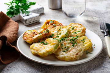 Fried zucchini slices with parsley