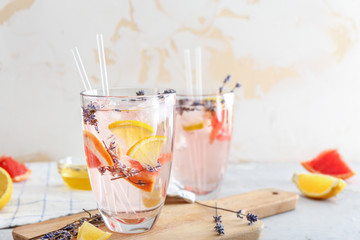 Glass with lavender lemonade on table