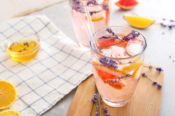Glass with lavender lemonade on table