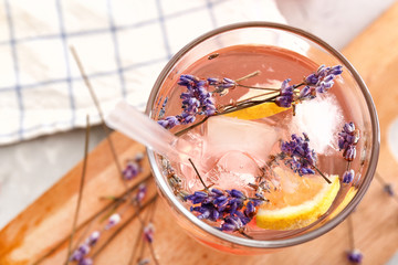 Glass with lavender lemonade on table, closeup