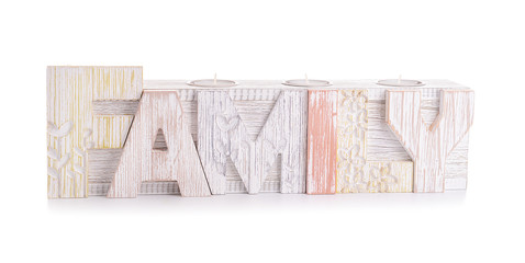 Wooden candle holder in shape of word FAMILY on white background