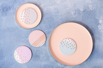 Stylish plates on color background
