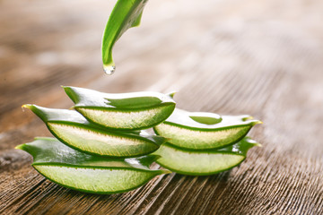 Slices of fresh aloe on wooden background