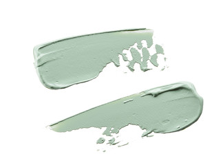 Gently green strokes and texture of face cream or acrylic paint isolated on white background