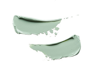 Gently green strokes and texture of face cream or acrylic paint isolated on white background