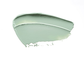 Gently green strokes and texture of face cream or acrylic paint isolated on white background